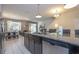 Open kitchen with granite countertops and seamless layout to dining and living areas at 3085 Tom Sawyer Dr, Kissimmee, FL 34746