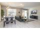 Bright living room featuring modern lighting, tile floors, neutral walls and comfortable seating at 3085 Tom Sawyer Dr, Kissimmee, FL 34746