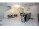 Open-concept living space featuring tile floors, seating area, and a modern kitchen island at 3085 Tom Sawyer Dr, Kissimmee, FL 34746
