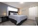 Bright bedroom features a king bed, gray accent wall, and natural light streaming through the curtains at 3085 Tom Sawyer Dr, Kissimmee, FL 34746