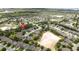 Community aerial view with a sand trap in the foreground and homes surrounding a central area at 3281 Saloman Ln, Clermont, FL 34711