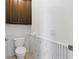 A modern bathroom with beautiful marble look accent wall and dark brown cabinetry at 3281 Saloman Ln, Clermont, FL 34711