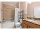Bathroom with bathtub and shower, toilet, dark metal shelving, and a granite-look vanity at 3281 Saloman Ln, Clermont, FL 34711