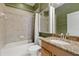 Bathroom with bathtub and shower, toilet, medicine cabinet, and a granite-look vanity at 3281 Saloman Ln, Clermont, FL 34711