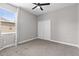 Bedroom with a ceiling fan, double door closet, gray walls, and a view to the outside at 3281 Saloman Ln, Clermont, FL 34711