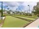 Bocce ball court with well-maintained green surface and surrounding landscaping under a sunny sky at 3281 Saloman Ln, Clermont, FL 34711