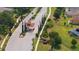 Aerial view of the community entrance, showcasing the well-maintained landscaping, guardhouse and fountain at 3281 Saloman Ln, Clermont, FL 34711