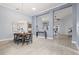 Open-concept dining area with light-colored flooring and views into adjacent living spaces at 3281 Saloman Ln, Clermont, FL 34711