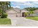 Charming home with a well-maintained front yard, three car garage, and inviting entrance at 3281 Saloman Ln, Clermont, FL 34711