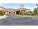 Elegant building with a grand entrance, meticulously landscaped gardens, and a welcoming driveway at 3281 Saloman Ln, Clermont, FL 34711