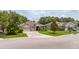 Beautiful front exterior of a well-maintained home with lush green lawn and mature trees at 3281 Saloman Ln, Clermont, FL 34711