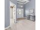 Bright foyer featuring a tray ceiling, white tile floors, and a modern console table at 3281 Saloman Ln, Clermont, FL 34711