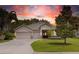 Well-maintained single-story home with a three-car garage, landscaped yard, and inviting front entrance at 3281 Saloman Ln, Clermont, FL 34711