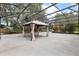 A partially enclosed gazebo offers a tranquil retreat within a spacious screened lanai at 3281 Saloman Ln, Clermont, FL 34711