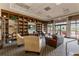 Cozy library featuring built-in bookshelves, comfortable seating, and bright windows for reading at 3281 Saloman Ln, Clermont, FL 34711