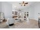 Spacious living room with tile floors, ceiling fan, and open access to the kitchen and dining areas at 3281 Saloman Ln, Clermont, FL 34711