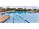 Large community pool with clear blue water, surrounded by lounge chairs and greenery for relaxation at 3281 Saloman Ln, Clermont, FL 34711