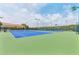 Well-maintained community tennis courts on a sunny day with blue and green surface and netting at 3281 Saloman Ln, Clermont, FL 34711