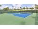 Community tennis courts with blue playing surface and green trim surrounded by tall fencing at 3281 Saloman Ln, Clermont, FL 34711