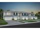 New townhome building featuring two-story construction, painted siding, and individual garages at 3342 Canyon Bay Pt, Sanford, FL 32773