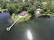 Aerial view showcasing a lakeside pier, gazebo, and community pool surrounded by trees at 353 Wekiva Cove Rd, Longwood, FL 32779