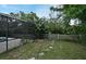Private backyard featuring a screen enclosure and lush greenery, creating a serene outdoor space at 353 Wekiva Cove Rd, Longwood, FL 32779