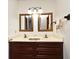 Bathroom with double sinks in a wooden vanity and large framed mirrors at 353 Wekiva Cove Rd, Longwood, FL 32779