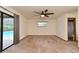 Bedroom with neutral carpeting, fan, and access to screened-in patio and pool at 353 Wekiva Cove Rd, Longwood, FL 32779
