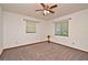 This bedroom has neutral carpet, natural light from the windows, and a ceiling fan at 353 Wekiva Cove Rd, Longwood, FL 32779