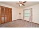 Bedroom featuring carpeted floors, a ceiling fan, a window, and a closet with louvered doors at 353 Wekiva Cove Rd, Longwood, FL 32779