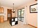 Dining area with tiled floors, modern light fixture, and sliding glass doors that offer access to the outdoor patio at 353 Wekiva Cove Rd, Longwood, FL 32779
