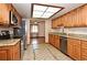Spacious kitchen with stainless steel appliances, granite countertops, and a seamless view to a sunny adjoining room at 353 Wekiva Cove Rd, Longwood, FL 32779