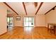 Spacious living room features wood floors, exposed beams, and sliding glass doors for seamless indoor-outdoor living at 353 Wekiva Cove Rd, Longwood, FL 32779
