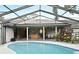 Inviting pool and patio area beneath a screen enclosure is perfect for entertaining and enjoying the outdoors at 353 Wekiva Cove Rd, Longwood, FL 32779