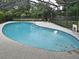 Inviting in-ground pool surrounded by a screen enclosure, perfect for relaxation and entertainment at 353 Wekiva Cove Rd, Longwood, FL 32779