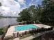 Beautiful community pool and hot tub overlooking a serene lake and surrounded by lush greenery at 353 Wekiva Cove Rd, Longwood, FL 32779