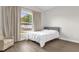 Cozy bedroom with a neutral palette, luxury vinyl plank flooring, and large window at 3622 Huntwicke Blvd, Davenport, FL 33837