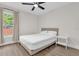 This bedroom offers a ceiling fan, beautiful hardwood floors, and a sun-filled window at 3622 Huntwicke Blvd, Davenport, FL 33837