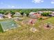 Community playground and basketball court in a neighborhood setting with houses and mature trees at 3622 Huntwicke Blvd, Davenport, FL 33837