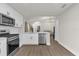 Open kitchen design with white cabinetry, stainless steel appliances, and luxury vinyl plank flooring at 3622 Huntwicke Blvd, Davenport, FL 33837