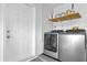 This is a laundry room with a washer and dryer and white wooden shelving at 3622 Huntwicke Blvd, Davenport, FL 33837