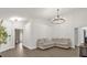 Spacious living room with modern lighting, neutral colors, and luxury vinyl plank flooring at 3622 Huntwicke Blvd, Davenport, FL 33837