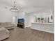 Open living room with luxury vinyl plank flooring, a chandelier, and neutral decor at 3622 Huntwicke Blvd, Davenport, FL 33837