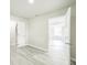 Bright bedroom featuring open door and gray flooring at 3823 Avenue R Nw, Winter Haven, FL 33881