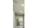Hallway with view of kitchen that has stainless steel appliances and granite countertops at 3823 Avenue R Nw, Winter Haven, FL 33881