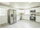 Updated kitchen with stainless steel appliances, granite countertops, and white cabinetry at 3823 Avenue R Nw, Winter Haven, FL 33881