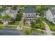 Aerial view of a yellow two-story home with manicured lawn and mature trees at 4065 Anissa Ave, Orlando, FL 32814