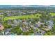 Aerial view of a neighborhood with homes, mature trees, parks, and a lake at 4065 Anissa Ave, Orlando, FL 32814