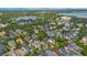 Aerial view of neighborhood with houses, lake, and buildings in the distance at 4065 Anissa Ave, Orlando, FL 32814