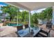 Relaxing backyard with covered patio, outdoor dining set, and inviting swimming pool at 4065 Anissa Ave, Orlando, FL 32814